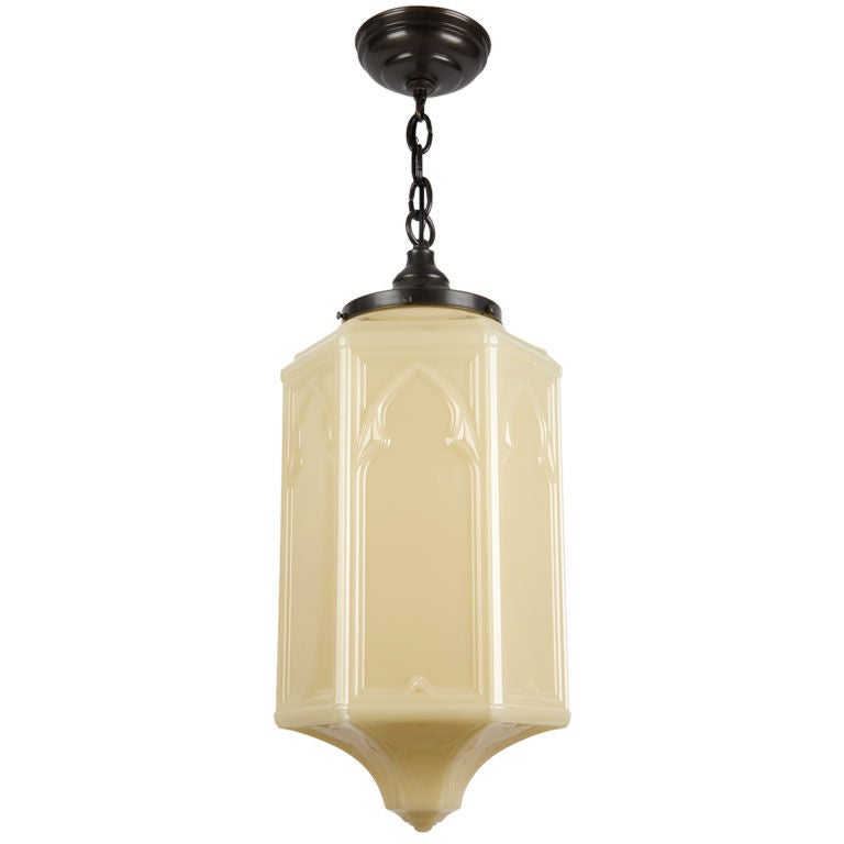 An opaque amber gothic glass pendant