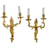 A pair of two arm foliate gilt sconces by the Sterling Bronze Co