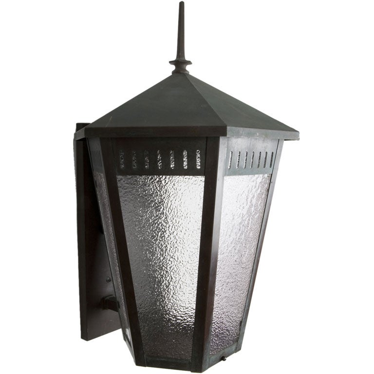 A hexagonal verdigris wall lantern