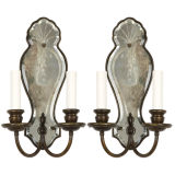 A pair of two arm mirrorbacked sconces