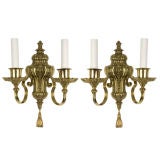 A pair of two arm brass Caldwell sconces