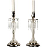 A pair of etched, wheel cut glass candelabras