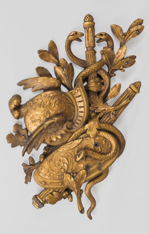 GR1066<br />
A cast iron figural plaque with an old gold paint surface depicting a shield, helmet and caduceus woven throughout with leafy branches.  <br />
<br />
Dimensions: 36