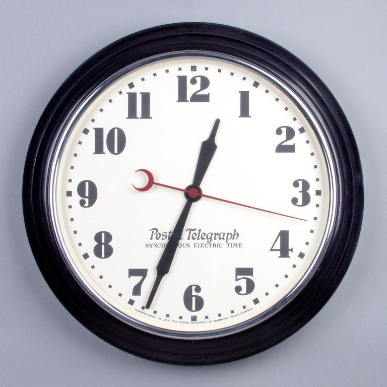 GR1048<br />
A large wall clock with a black enamel case and a hand painted face.<br />
<br />
Diameter: 20