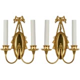 A pair of gilded bow topped sconces