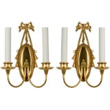 A pair of gilded bow topped sconces