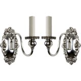 A pair of single-arm silver Sheffield sconces