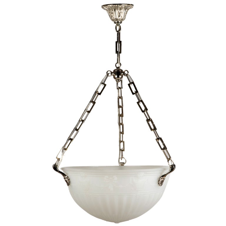 AHL3404
A fluted and urn decorated cast opaline glass inverted dome with darkened brass foliate mounts and canopy. Due to the antique nature of this fixture, there may be nicks or imperfections in the glass. 

Current height: 40