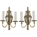 A pair of gilt and silvered two-arm sconces