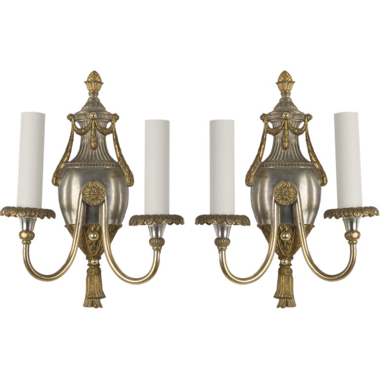 A pair of gilt and silvered two-arm sconces
