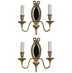 A pair of double-arm mirrorback sconces