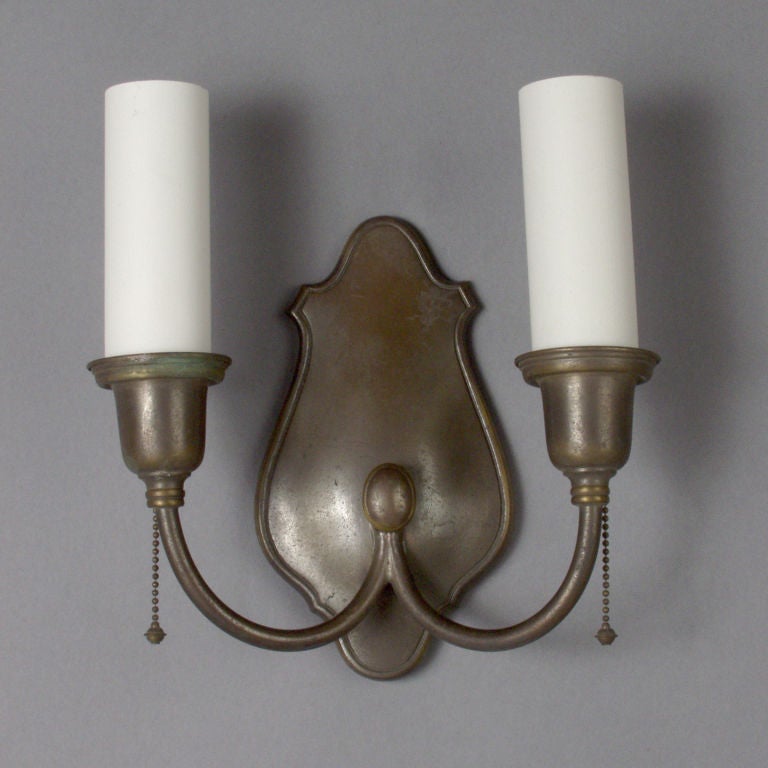 A pair of shield-back sconces by Bradley & Hubbard