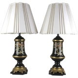 A pair of black ceramic lamps with bird motif