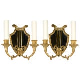 A pair of lyre form mirrorback sconces