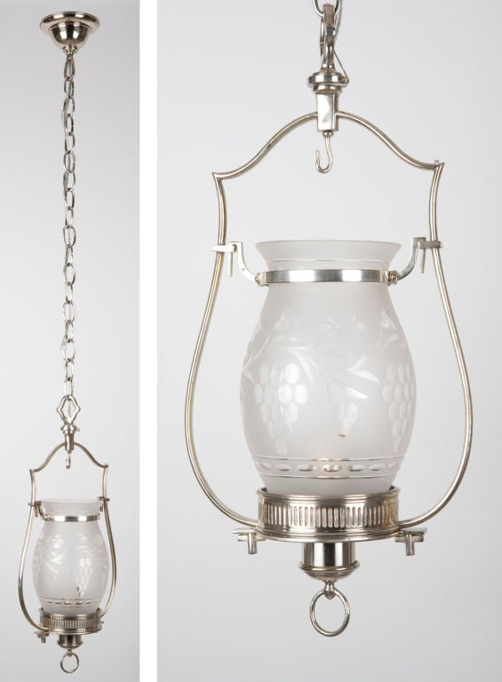 AHL3262<br />
A finely worked silverplate lantern having an etched, wheel cut hurricane shade.<br />
<br />
Current height: 46