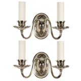 A pair of two-arm silverplate sconces A pair of two-arm silverplate sconces