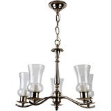 A five arm silverplate chandelier with hurricane shades