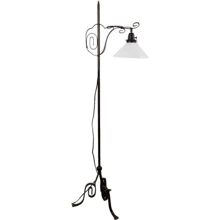 An adjustable bridge-arm wrought iron lamp