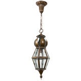 A hexagonal hammered brass lantern