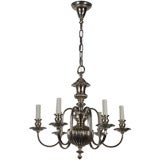An antique six-light silver chandelier with gadroon