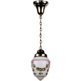 An antique hand-painted cased white glass pendant
