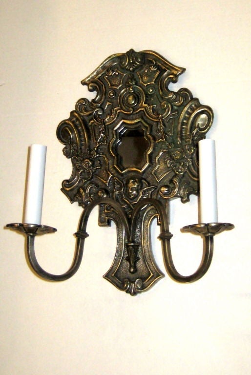 Pair of Italian silver plated sconces with scrolling motif and cherub decorations. Mirror inset.
Measurements:
Height: 16