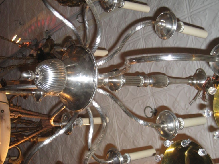 A circa 1920's English silver plated chandelier with 12 lights.

Measurements:
Minimum drop: 32