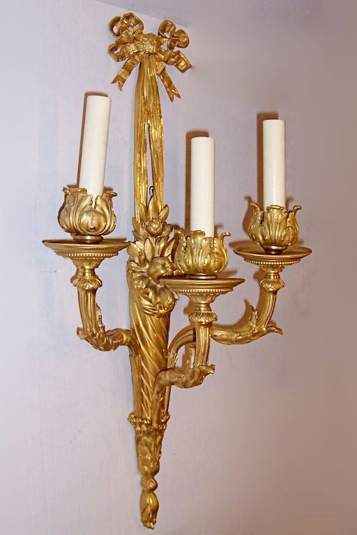 Pair of circa 1900 French gilt bronze Louis XVI style sconces. 
Visit our website for our extensive antique sconces selection.
Available at our showroom at 241 East 60th Street, NY, NY  212-751-2282
