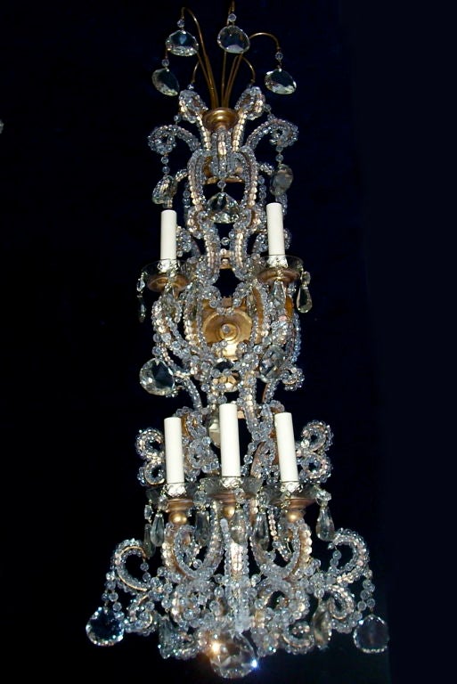 Pair of circa 1920 Italian sconces with beaded body and crystal drops.
Monumental bodies with a gold leaf finish and with crystal and glass beads and pendants.
Five lights each.