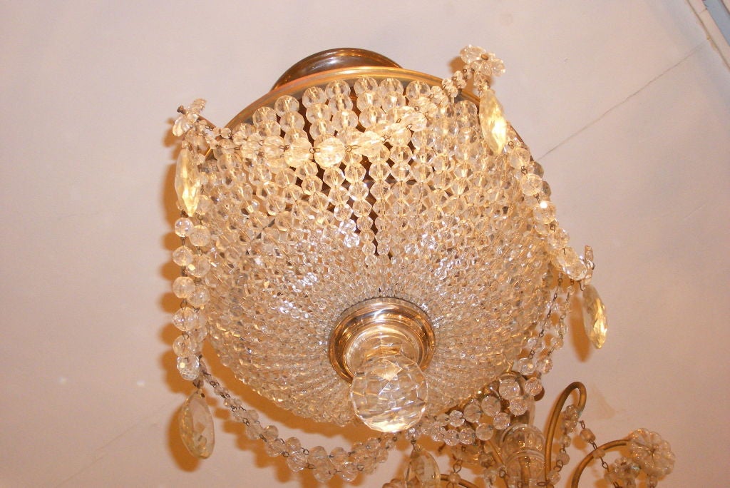 A patinated bronze and crystals basket chandelier with interior lights. 

14
