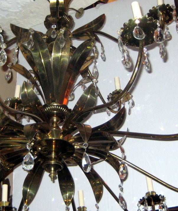 Gilt bronze three-tiered chandelier with leaf details and with crystal drops, circa 1960s. Three available. Sold individually.

Measurements:
Height 49
