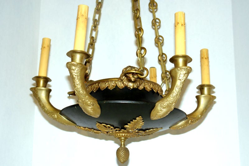 A late 19th century French Empire-style chandelier with gilt and painted finish. 
Measurements:
Diameter: 18
