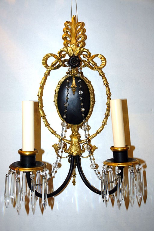A pair of circa 1920's Caldwell gilt bronze neoclassic style sconces with painted detailing.

Measurements:
Height: 15.5