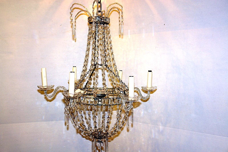 A late 19th century Swedish six-arm crystal chandelier.

Measurements:
Height: 31
