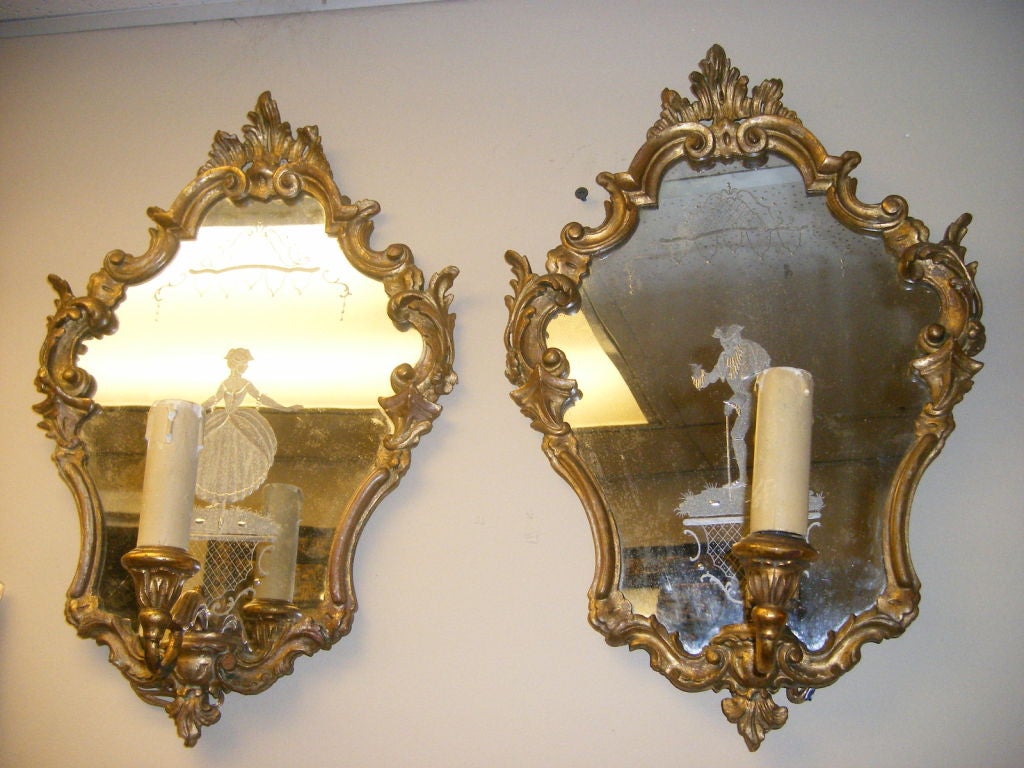 Pair of carved and gilt wood Venetian sconces with etched figures on back plates.<br />
17