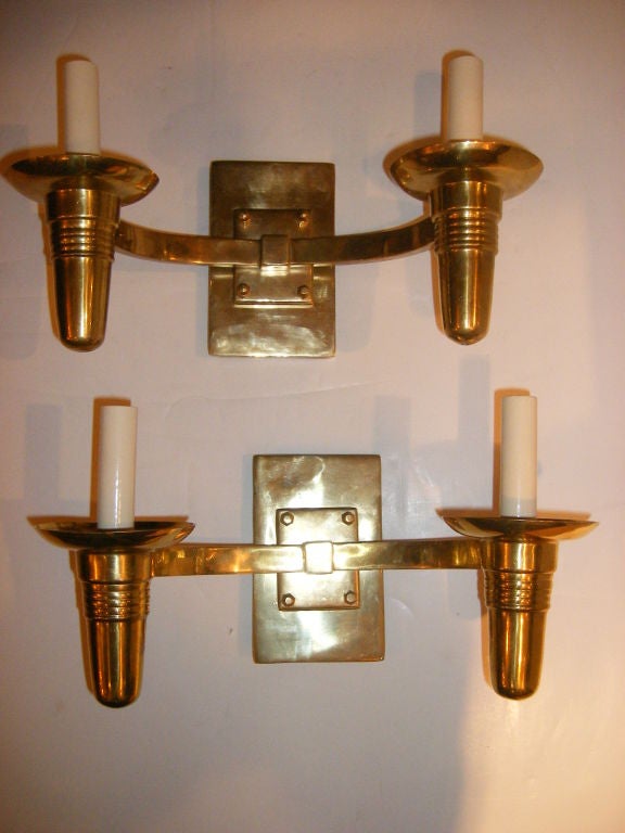 A set of eight matching Moderne style bronze two-light sconces. 
With original finish and patina. 
Measures: 13.5