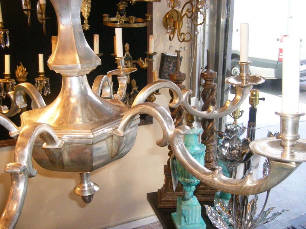 A large, silver plated three-tiered neoclassic style English chandelier with original finish and patina.
Measures: 73