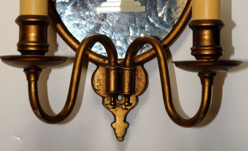 A pair of circa 1920's Caldwell gilt metal sconces with etched mirror backs in floral motif.

Measurements:
Height: 11