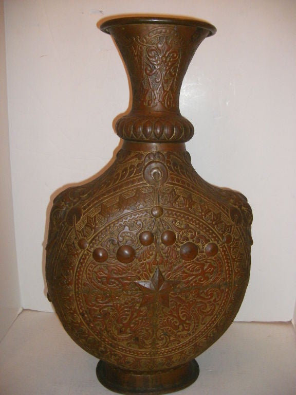 A circa 1920's Turkish hammered copper vase with elephant details on sides.

Measurements:
Height: 23