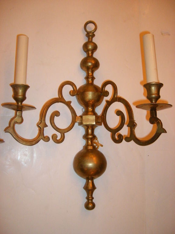 Pair of 1940s brass double light sconces, original patina.

Measure: 18" tall, 13" wide, 3" deep.