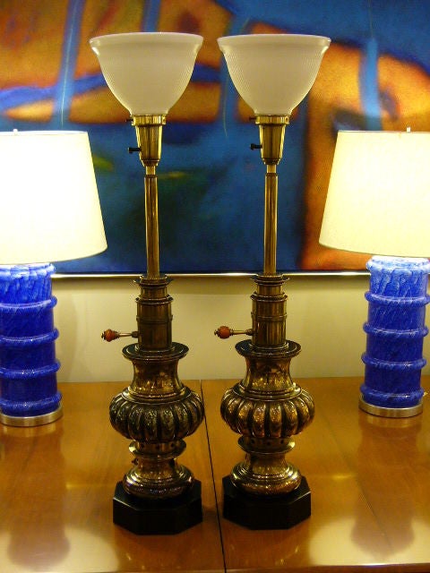 .SOLD DECEMBER 2010...Large and Rich Brass patinated pair of Stiffel Lamps in the form of antique oil lamps with bakelite on/off switchs.  Beautiful baluster urn shapes in antiqued brass and bases black patinated.  Stem rises to milk glass