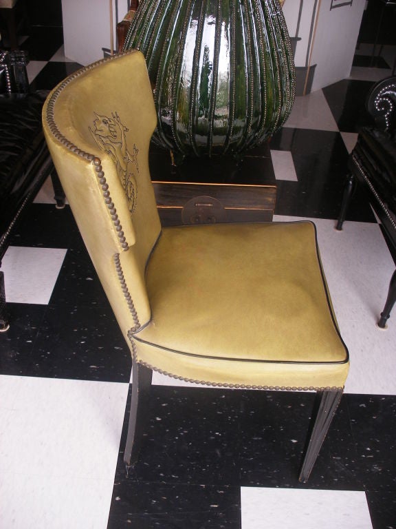 PAIR OF GREEN VINYL KLISMOS STYLE CHAIRS FROM THE 1950S.  ASIAN - DRAGON DESIGN ON THE BACK OF THE CHAIRS.