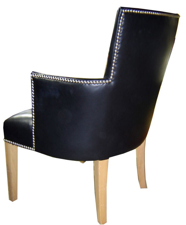 A large, comfortable French art deco armchair from the 1930’s.  The pale beechwood legs contrast with the soft black Edelman leather upholstery.  Add the silver studs in Greek Key pattern and you have French elegance at its very best.  The chair