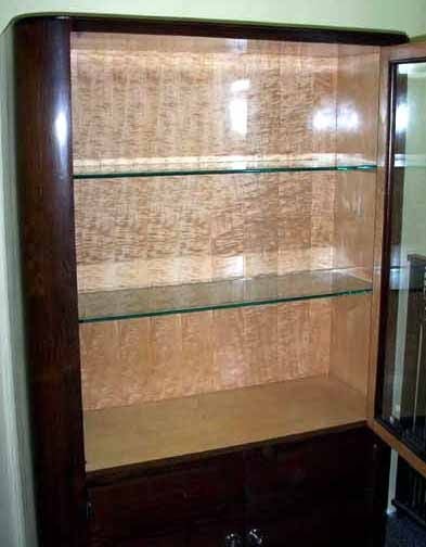 This French art deco African rosewood vitrine with its blond sycamore interior dates from the 1930's. From its lap feet with scrolls to its nickel hardware to its beveled glass door it will display your prized possessions in the best of taste. The