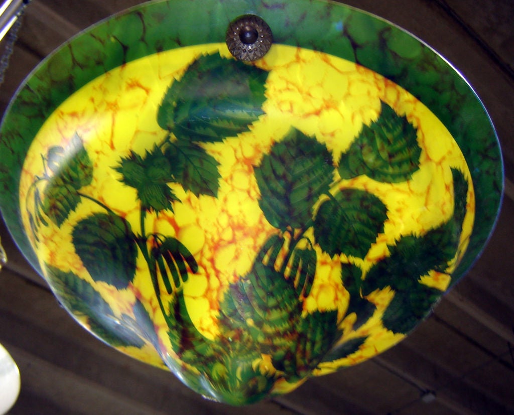 This Czechoslovakian art deco ceiling light is signed in the cameo “Venus Glas” and “Cewebo” and is from the 1930’s.  The yellow with orange striations glass is overlaid with a green glass upper layer which is acid etched to reveal tumbling leaves