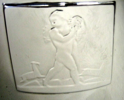 Lurelle Guild (1898 - 1986) designed this American art deco wine cooler in 1934 for the Chase Brass & Copper Company.  Constructed of chrome plated copper, the cooler has a relief placque designed by Rockwell Kent (1882 – 1971) depicting the child