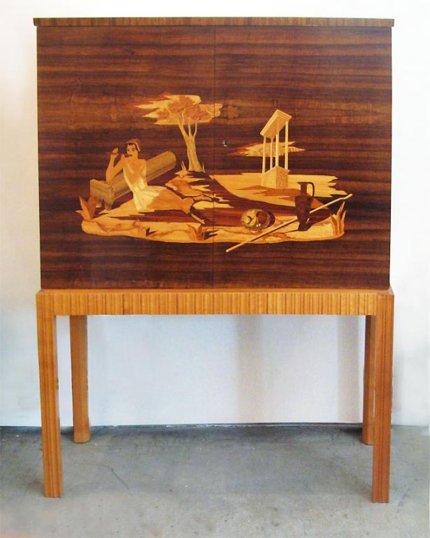 Swedish 1940's bar cabinet with beautiful marquetry detailed in a variety of exotic woods. Interior is finished in flame birch with palisander details. Made by Mjolby Intarsia, designed by Erik Mattsson. Dimensions H: 53 1/4” , Depth: 16