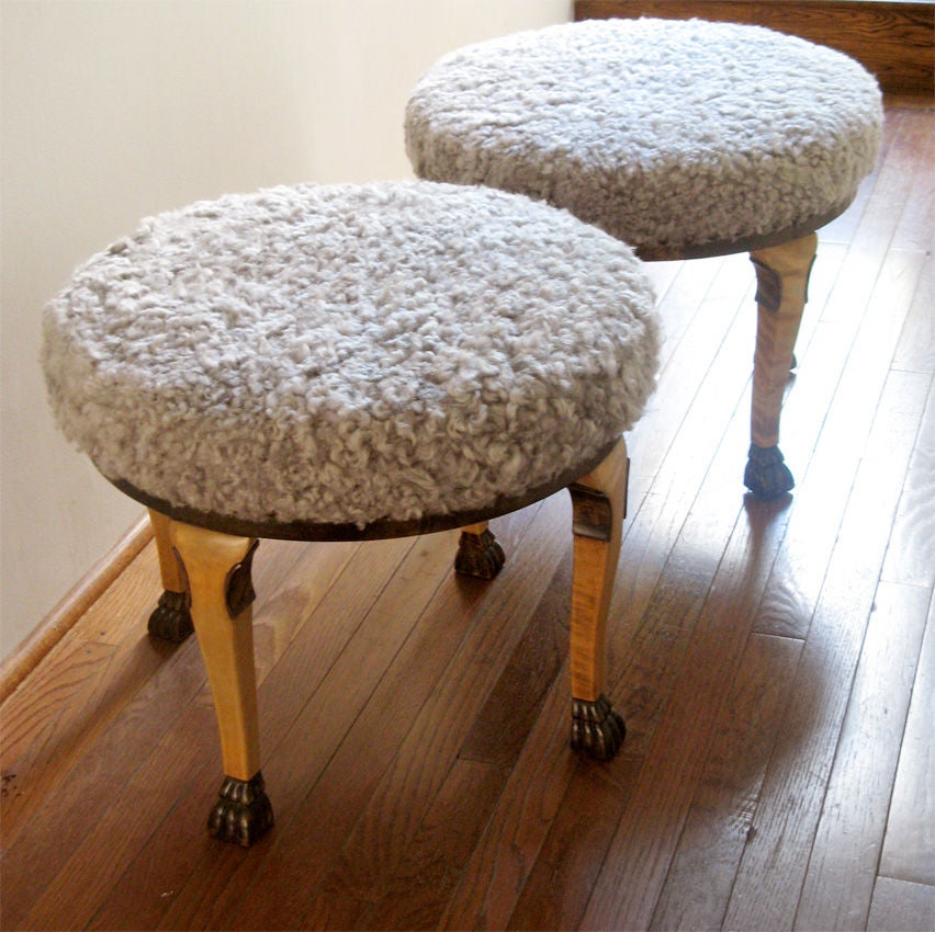 Rare pair of 1920’s Neoclassical inspired Swedish Art Deco stools made from flame Baltic birch with stained carved feat and upholstered in lamb skin. Made by and signed 