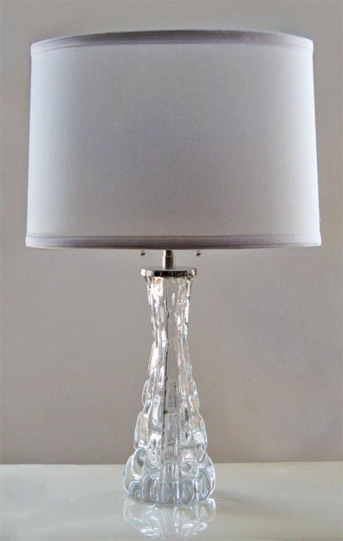 Pair of Swedish, clear crystal table lamps with nickel plated hardware designed by Carl Fagerlund. Each lamp has a stem with double cluster sockets and pulls. Newly rewired, lamps have original paper labels and engraved on bottom and stamped. Body