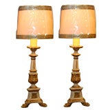 Pair of painted and gilded pricket lamps